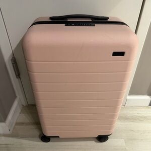 Away Bigger Carry On luggage Plush pink with battery
